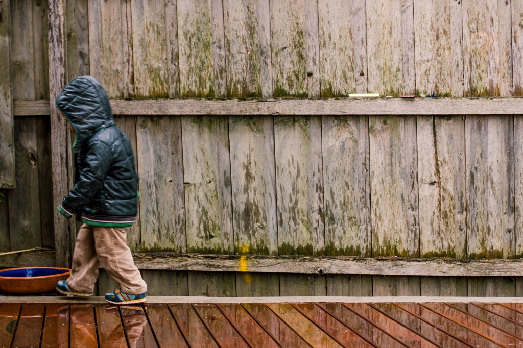 A storm had just come through and the light was amazing. Our deck had just been completed and Xavier was out playing in the residual rain. I got this shot set up while he was playing and then asked him to turn around and smile. He chose to walk off. If he had a speech bubble it would say 'Yeah sure Dad, I'll just stand here and smile while you take a photo. Idiot.'