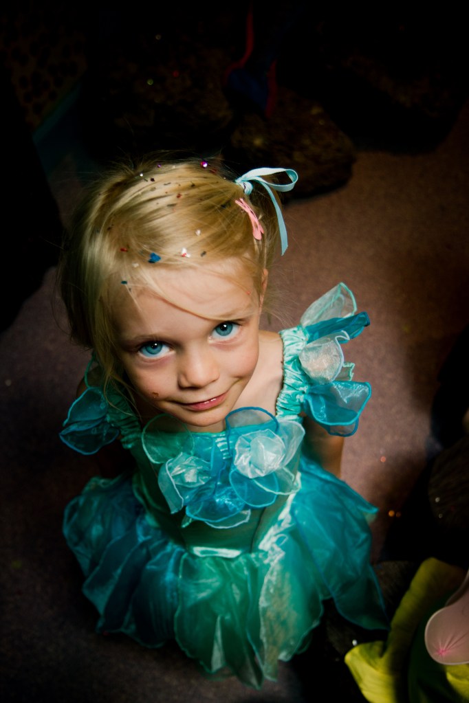 At age 3 Holly told me to 'Take the camera off your face'...so it's fair to say getting photos of her has been a challenge since then. She had her 5th birthday party at Fairy Fields and in one room the only light was coming through a skylight, I stood up on a chair and asked her to look up and before she could complain I took the shot. If I ever take a better shot of her, I will be a very happy man.
